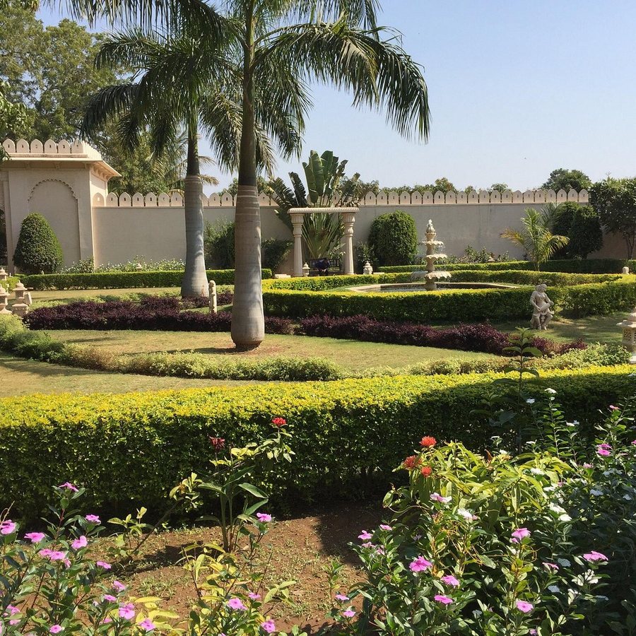 Geometric clipped hedging with flower beds in a formal garden